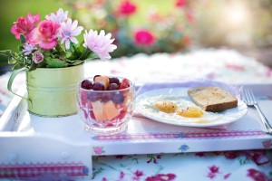 beautiful breakfast of eggs and toas laid out for a picnic in a sunny field